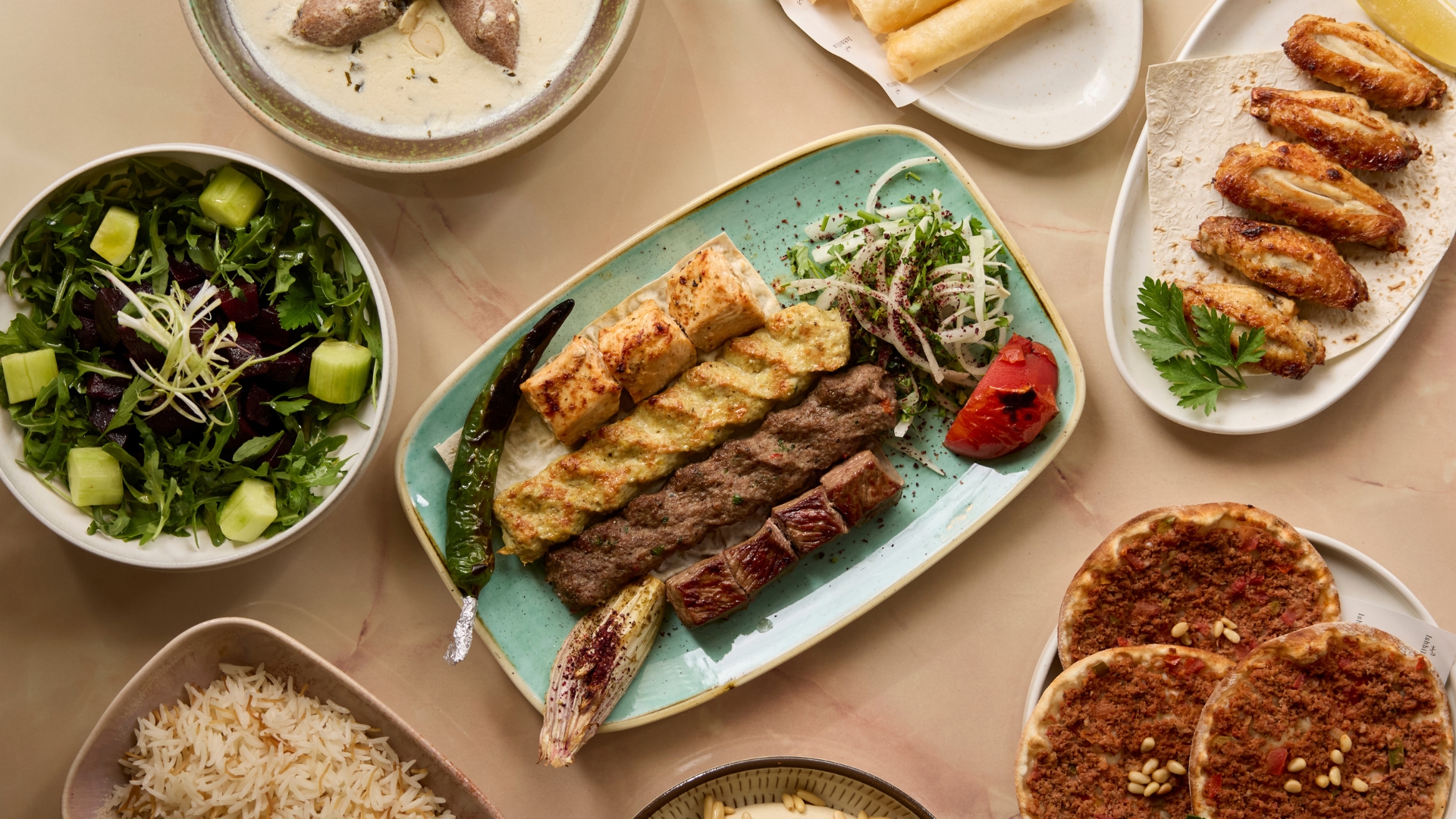 an image of a range of food at Ishbilia including mixed grill, lebanese vermicelli, hummus, and more