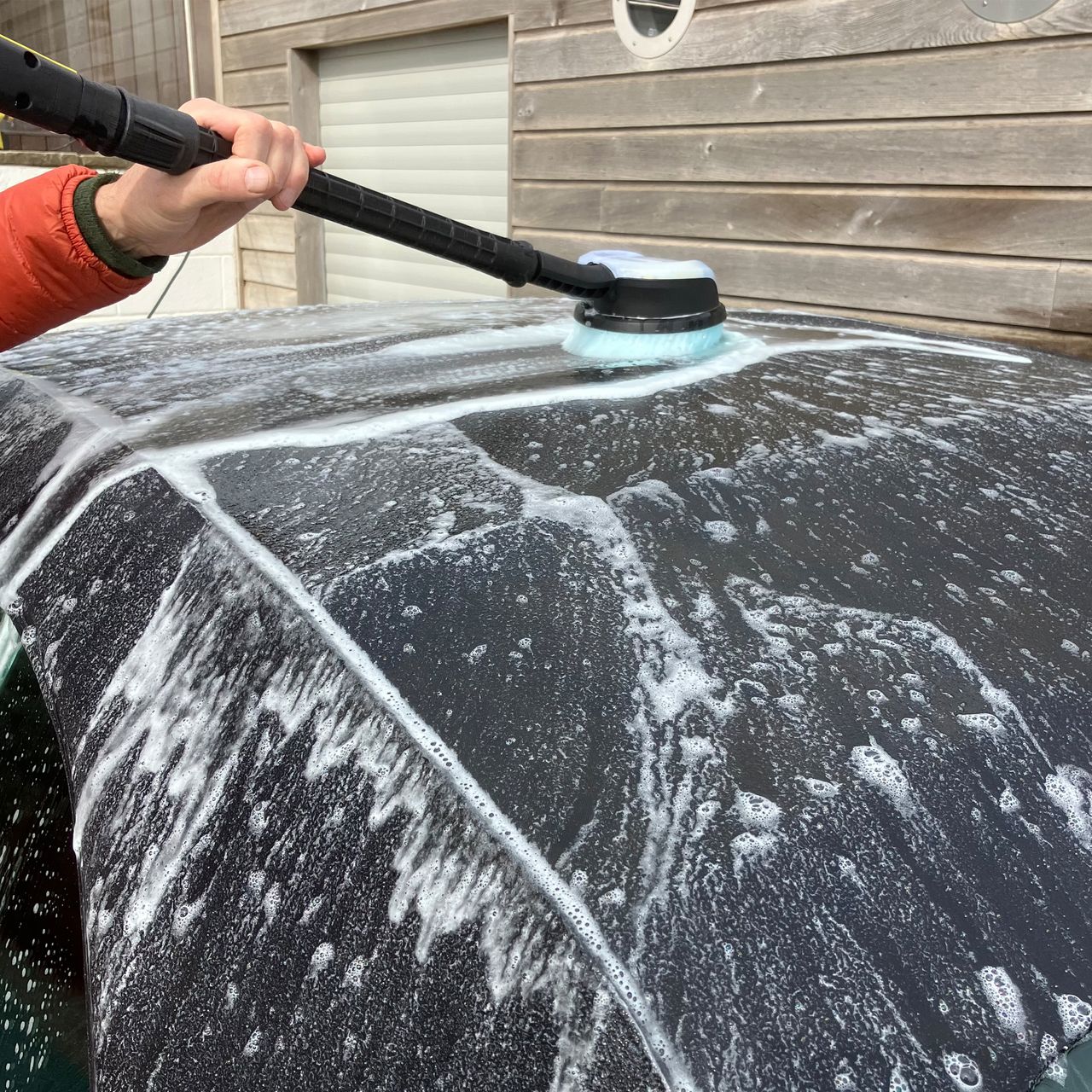 Pressure washer testing on patio, wood and a car