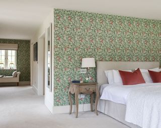 Bedroom with William Morris wallpaper in country house in Wiltshire