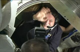 Russian cosmonaut Fyodor Yurchikhin, Expedition 37 commander, waves farewell as his crew enters a Soyuz TMA09M spacecraft to leave the International Space Station and return to Earth on Nov. 10, 2013.