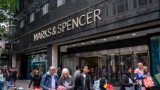 Pedestrians pictured walking past a Marks & Spencer (M&S) store front on Oxford Street, London.