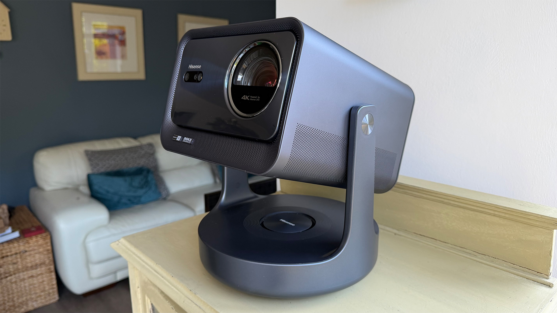 Hisense C2 Ultra home cinema projector on wooden shelf in living room
