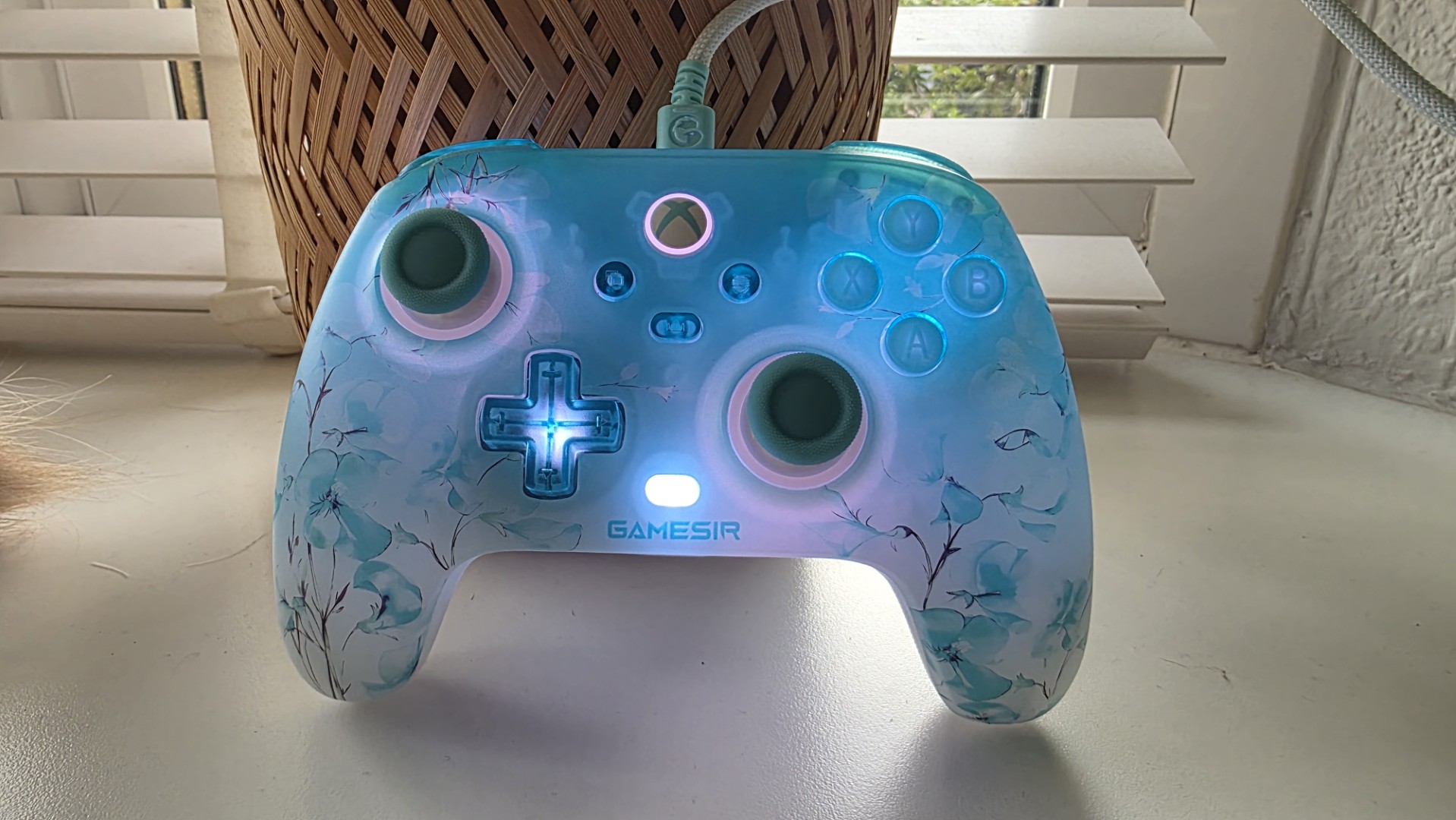A blue and white controller with floral pattern