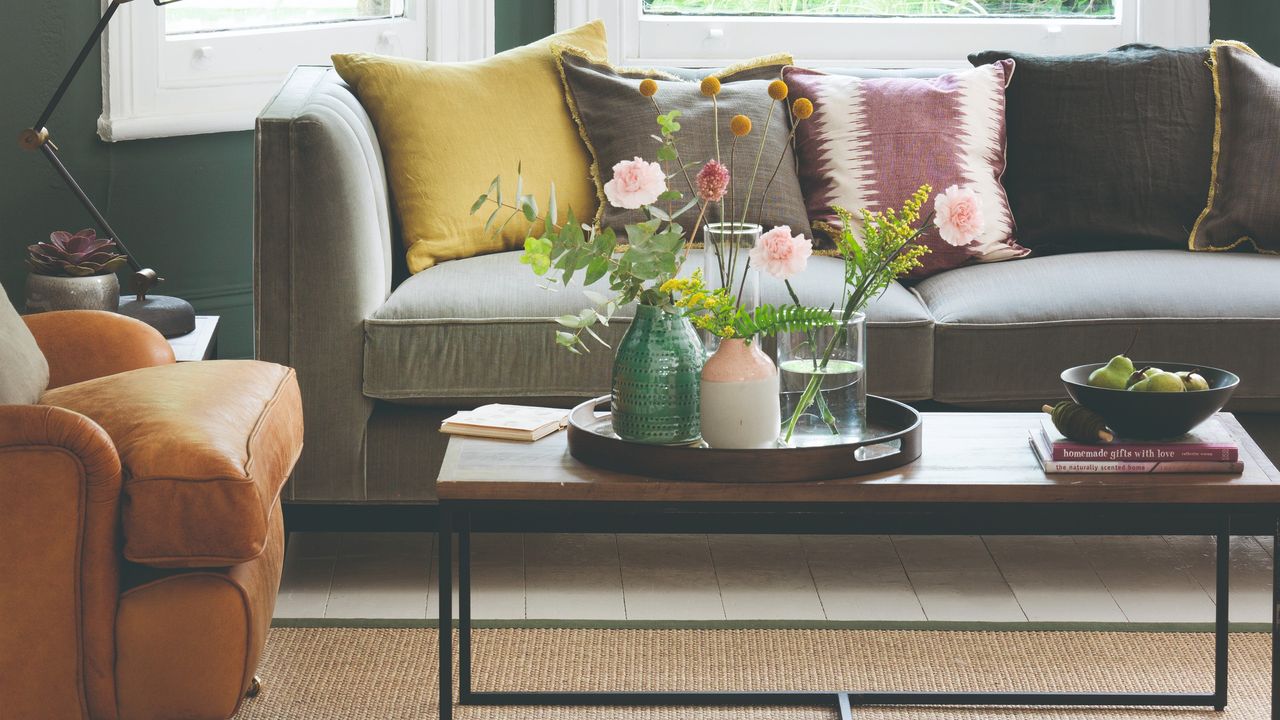 A living room with a jute rug and a grey sofa