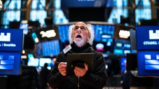 Trader Peter Michael Tuchman reacts as he works on the floor of the New York Stock Exchange during morning trading on April 15, 2025 in New York City.