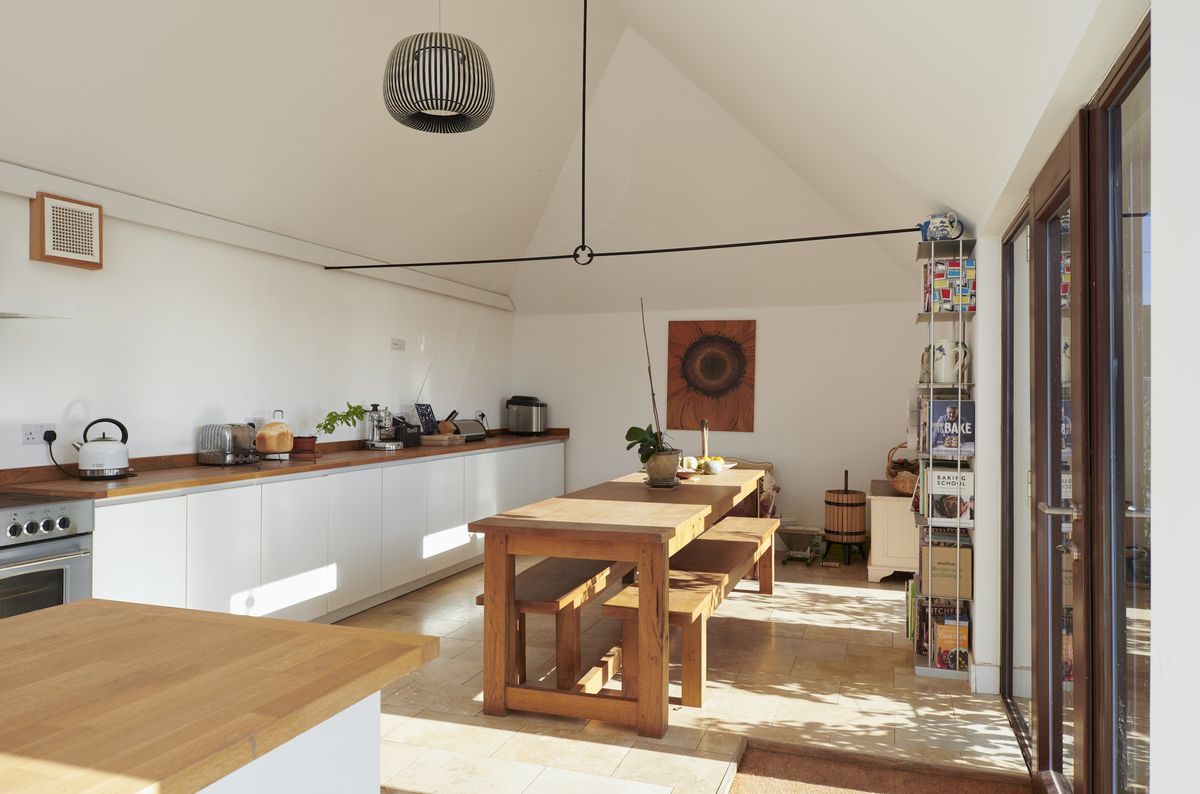 The interiors benefit from plenty of natural light thanks to the large windows and doors.