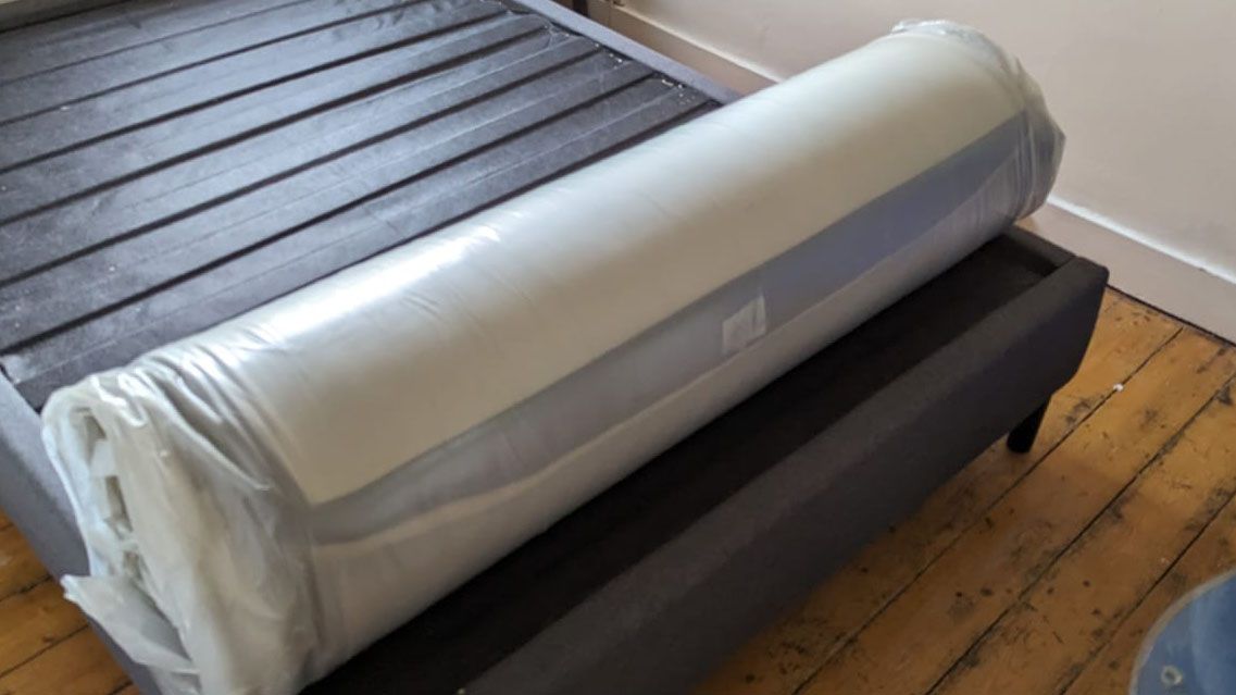 Panda Hybrid Bamboo Mattress, vacuum packed and rolled on the bed frame in reviewer's bedroom