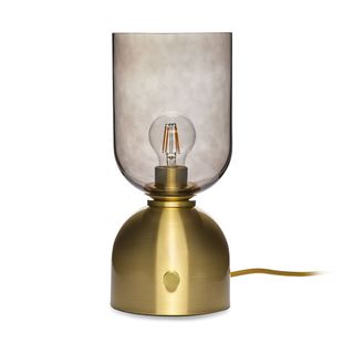 A brass gold lamp base with a mottled glass lampshade