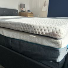 A side view of the Emma Premium mattress topper on a bed in a bedroom ready to be reviewed