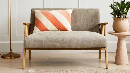 Mid-century modern compact sofa with rectangle diagonal stripe pillow