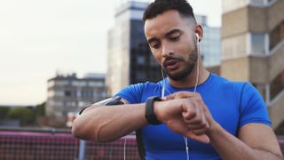 Man checking sports watch during run