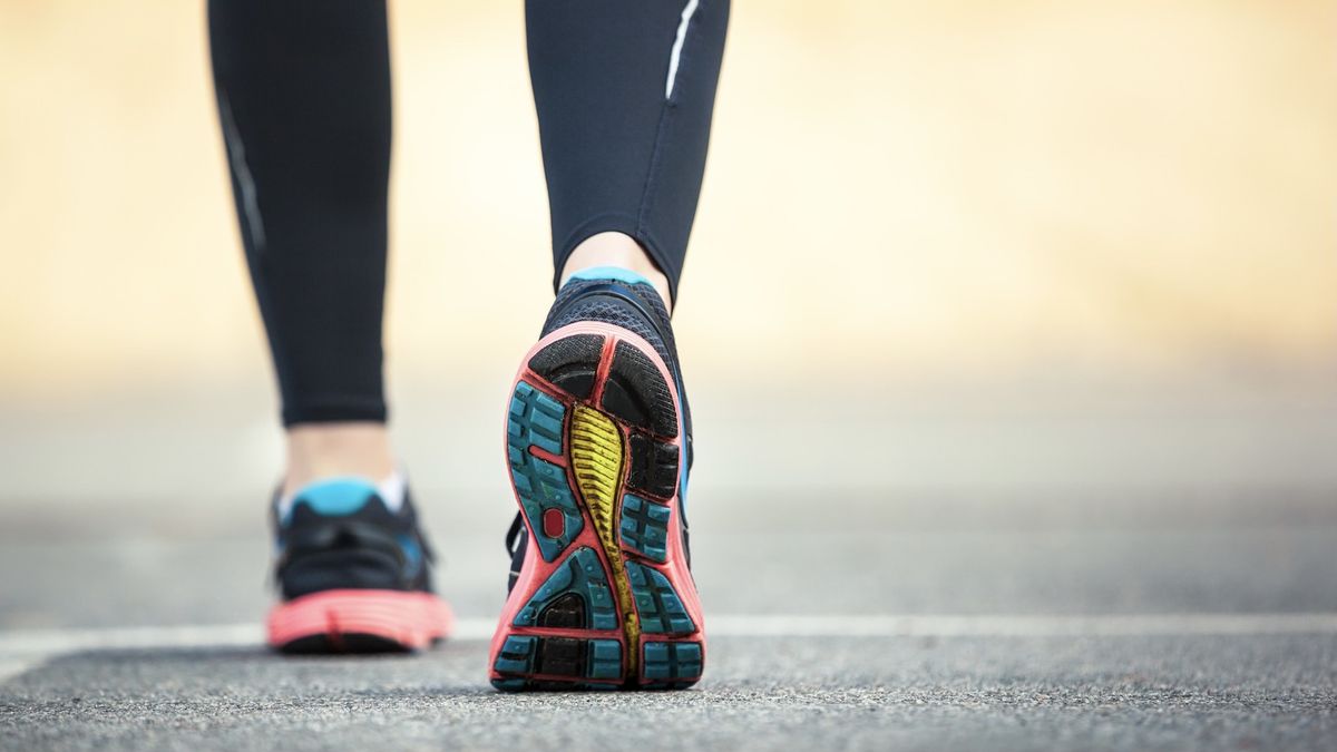 Woman&#039;s feet wearing road running shoes