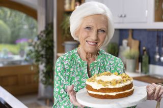 Mary Berry poses with a cake