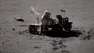 Astronaut and lunar rover on the surface of the moon.
