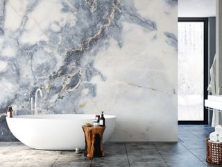 modern bathroom with marble wall mural and white bath