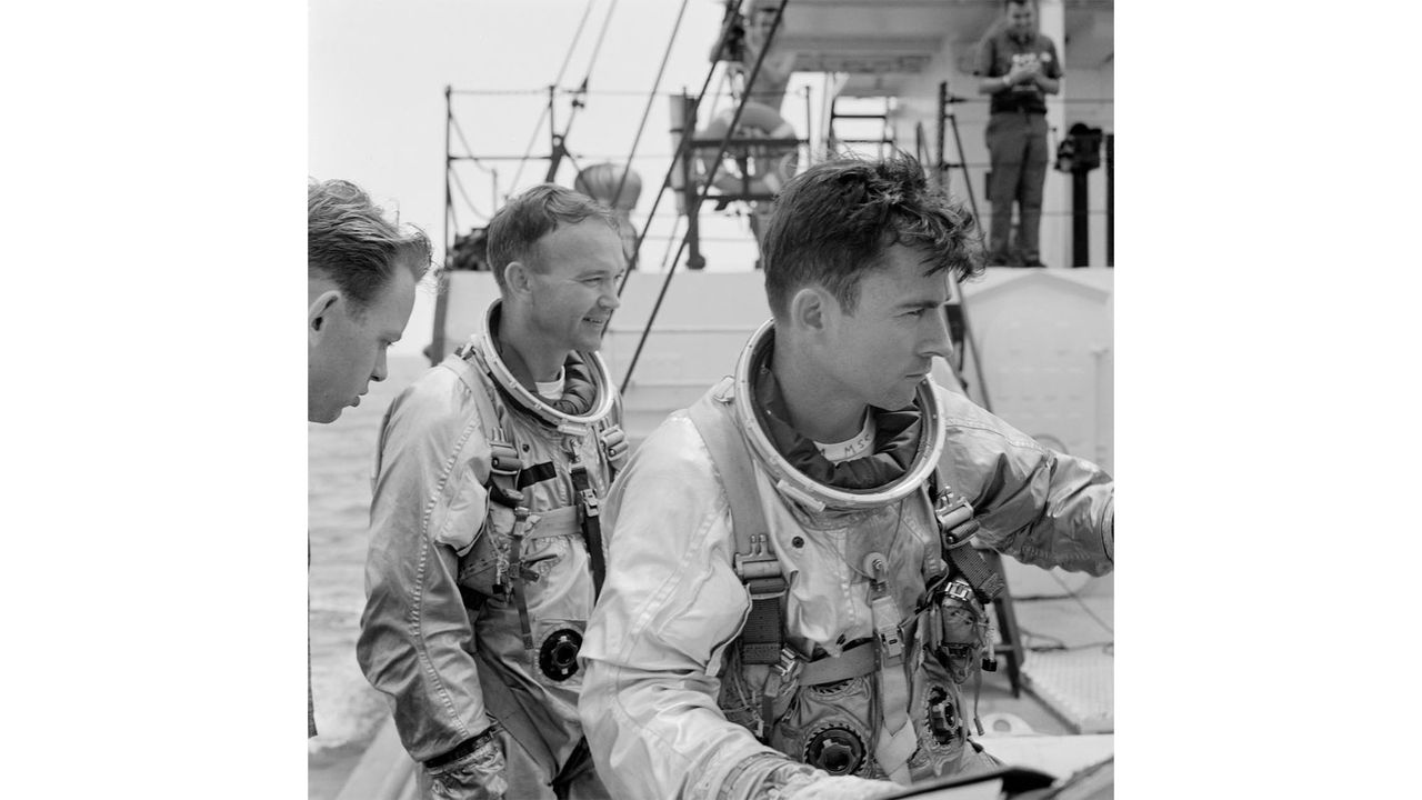 Astronauts Michael Collins (left) and John W. Young (right) on board NASA's Motor Retriever during a water egress training activity.