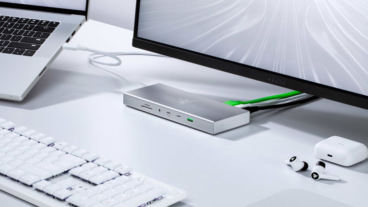 The silver Razer USB4 Dock on a white desk.