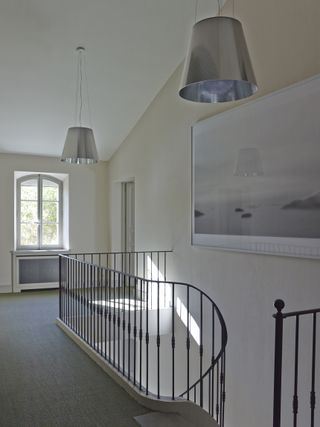 Landing with metal banisters and hand rail and neutral decor
