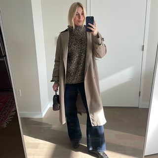 Editor Wearing Sweater, Jeans, and Trench Coat