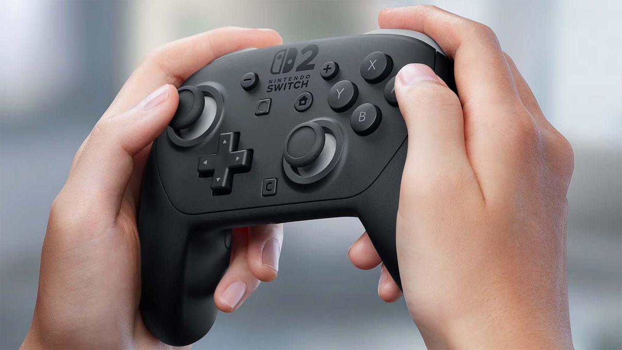 Nintendo Switch 2 Pro Controller being held up by two hands.