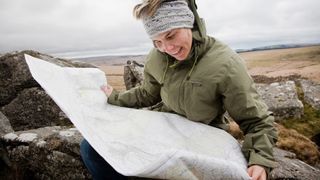 Woman looks at map on Dartmoor