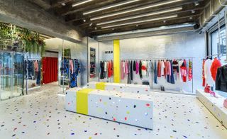 The new boutique is lined with colourful Venetian terrazzo, offset against raw ceiling beams