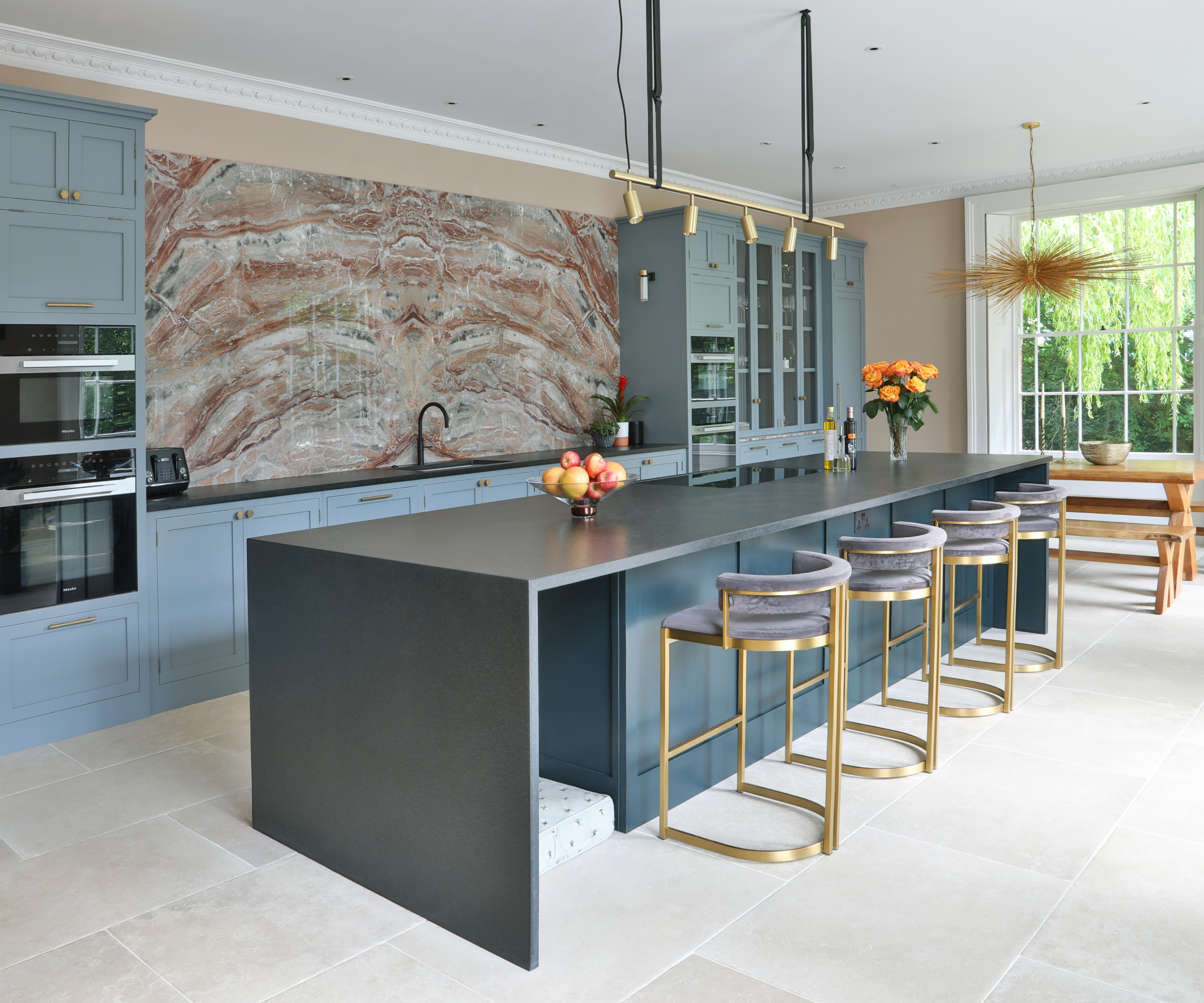 airforce blue long kitchen island with space to one end on the inside for dog bed