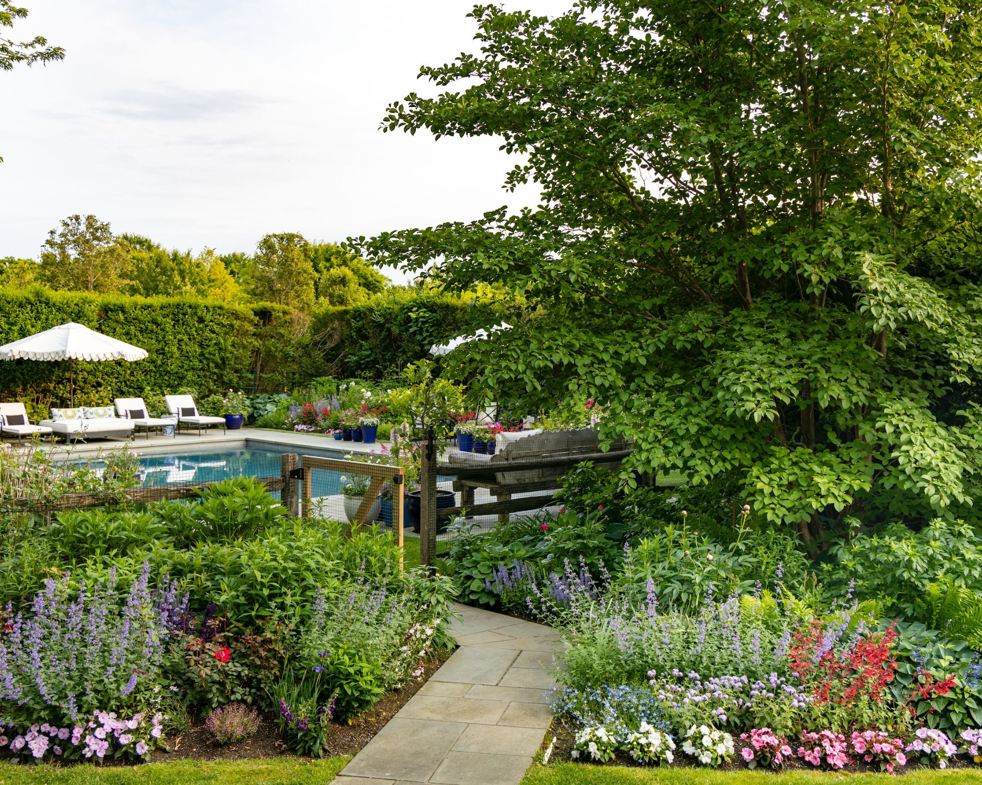 Flower beds leading to a swimming pool