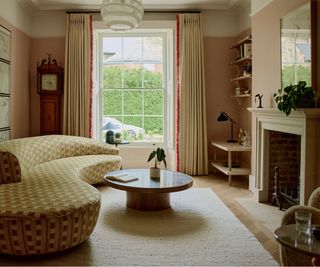 living room with fireplace, curved sofa and round coffee table