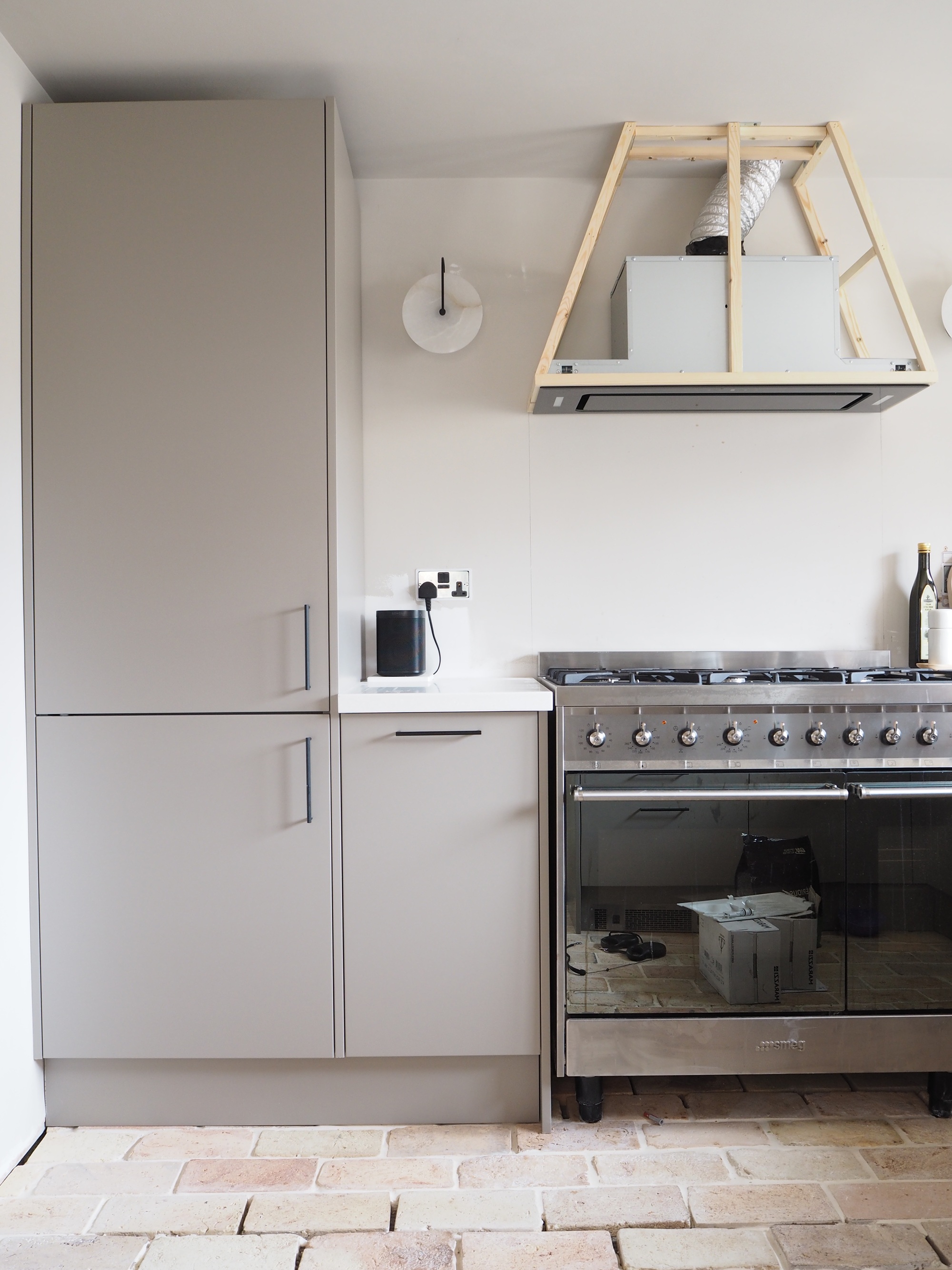 a kitchen, half way through construction, with an open extractor hood construction