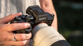 The Sony A7S III being held by a photographer