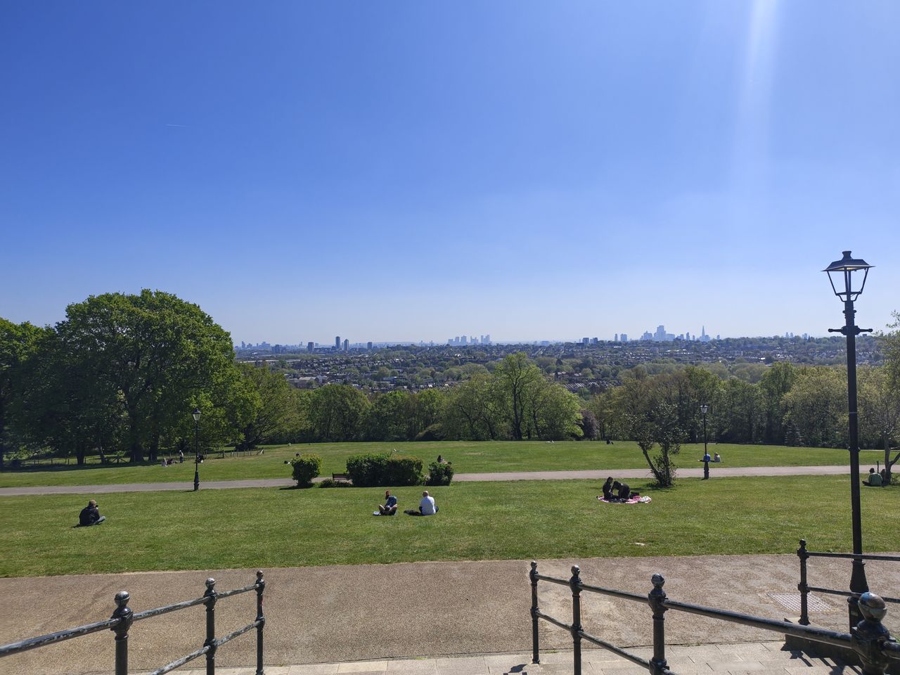 A camera sample taken on the Motorola Edge 70 Fusion, showing a park and distant city-scape.