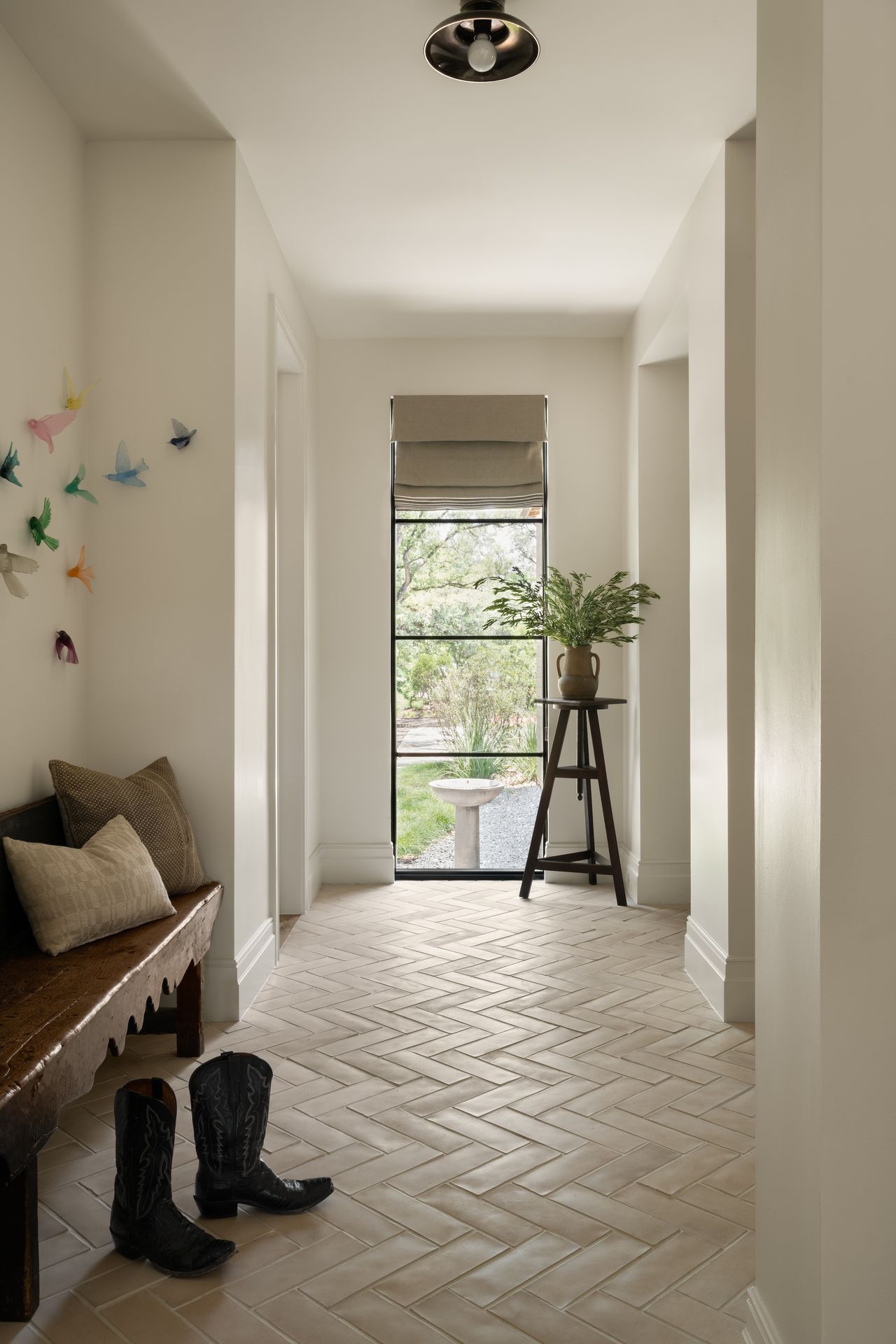 White bricks in a herringbone pattern in a hallway