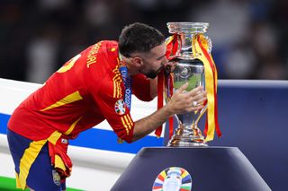 Dani Carvajal kisses the European Championship trophy after Spain's win against England in the final of Euro 2024.