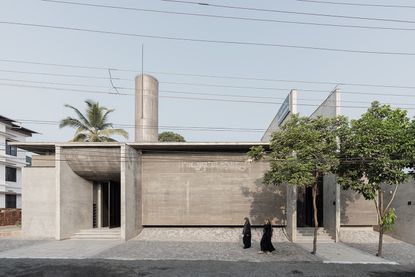 Brutalist mosque in Kerala, concrete structure against blue skies