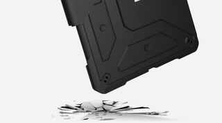 The corner of a black UAG ipad case hitting a surface 