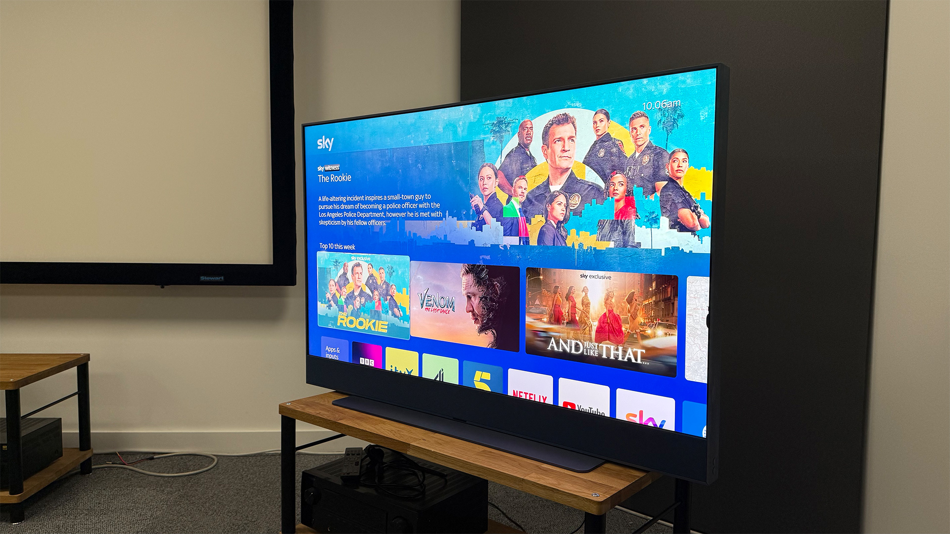 Sky Glass Gen 2 TV, soundbar and streaming service on wooden AV rack slight angle from right with Sky on screen