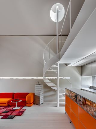 concrete interiors with orange accents at terada house in Tokyo