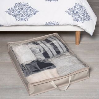 An under bed storage bag next to a bed