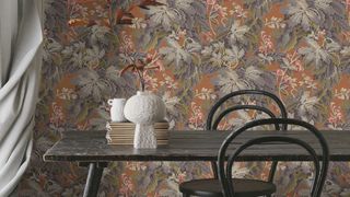 Brown floral wallpaper from Woodchip & Magnolia in a dining room with a wooden dining tablet in front of it