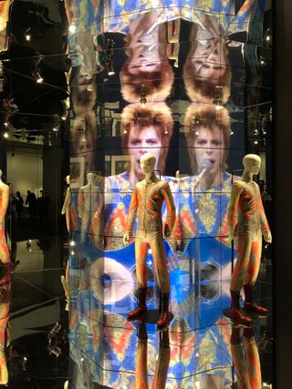 A mirror-lined chamber in the center atrium envelops a glam-costumed mannequin with rear-projected performance footage of Bowie in that outfit.