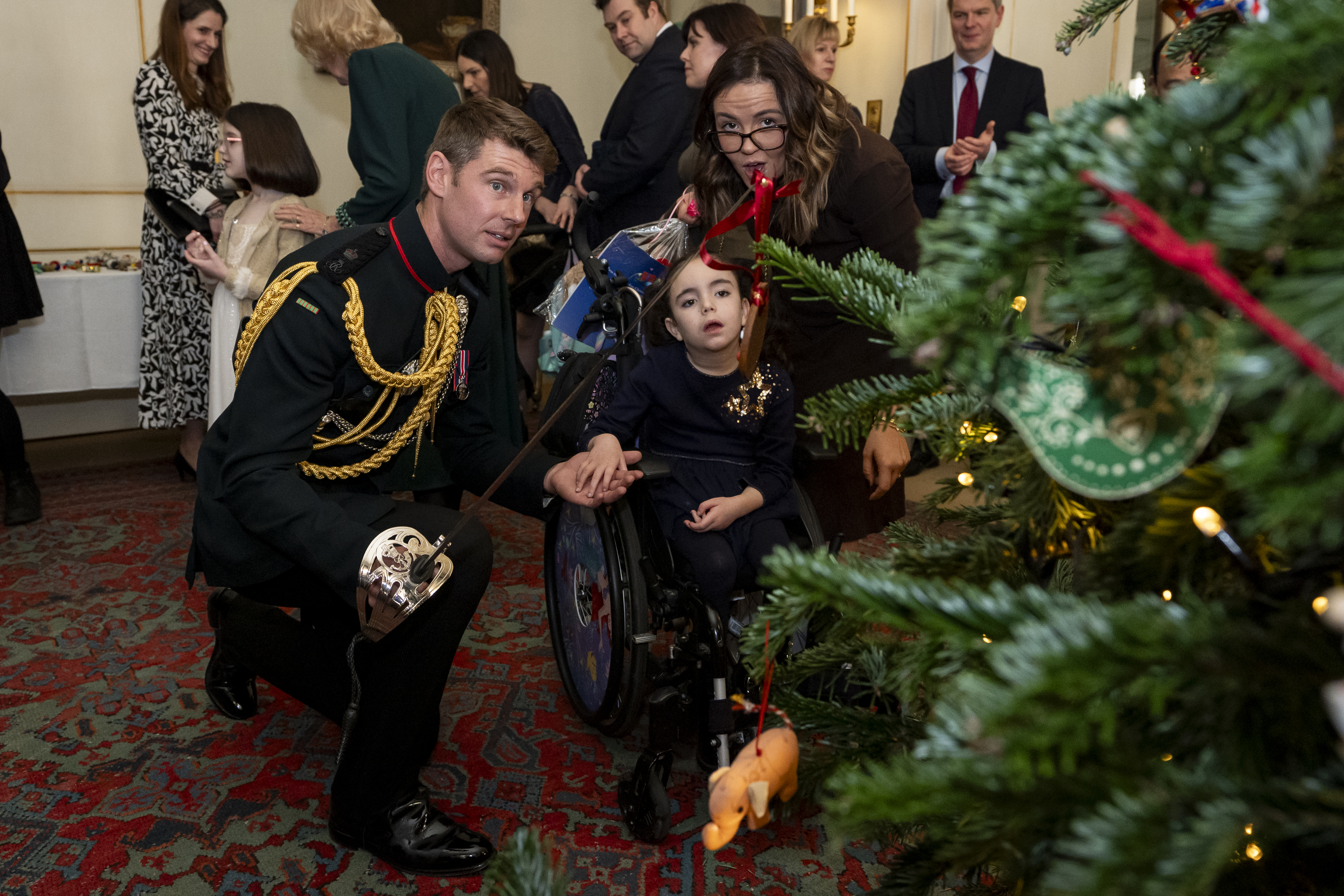 Rob Treasure decorating a christmas tree with a sword