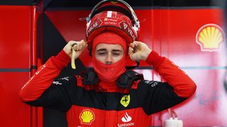 F1 driver Charles Leclerc of Monaco and Ferrari prepares pulls on his red helmet and prepares for the 2024 Saudi Arabian Grand Prix.