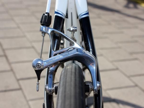 The SRAM Red brake caliper gleams in the sun after a dry training ride.