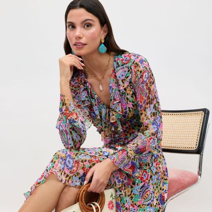 a model wearing a floral rixo dress