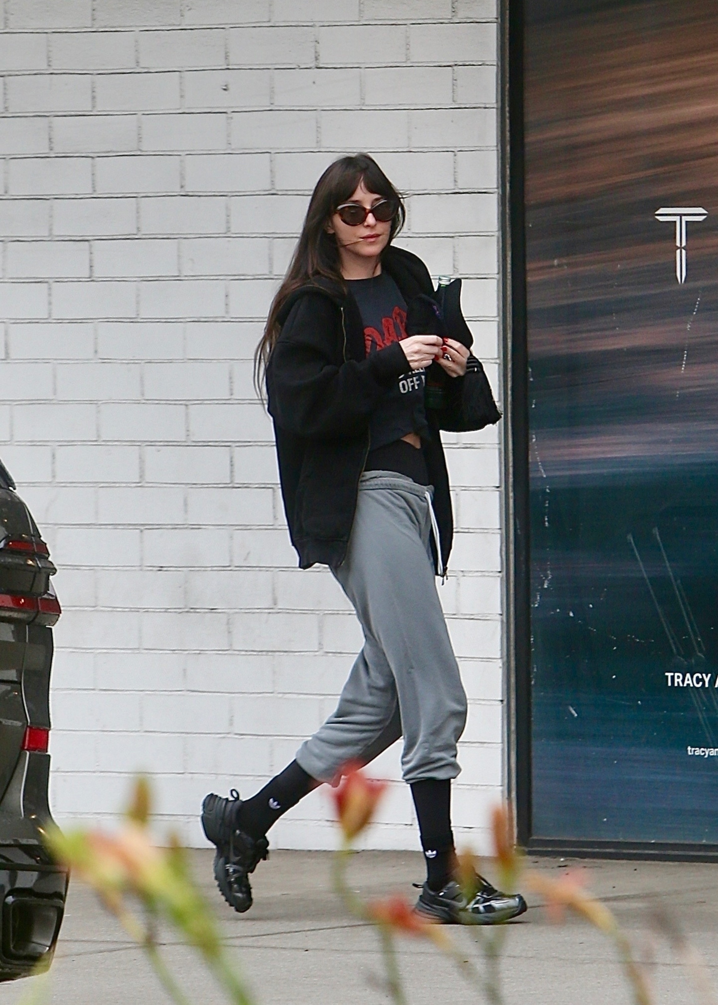 An image of Dakota Johnson wearing futuristic accent trainers.