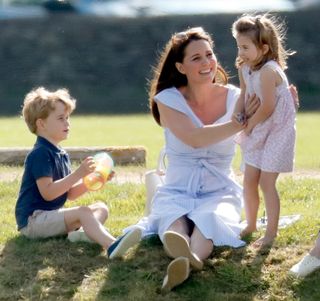 Prince George of Cambridge, Catherine, Duchess of Cambridge and Princess Charlotte of Cambridge attend the Maserati Royal Charity Polo Trophy