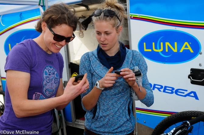Luna teammates Georgia Gould and Maghalie Rochette discuss settings on their new bike computers