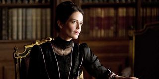 Vanessa Ives (Eva Green) sits at an ornate chair in a library in Penny Dreadful