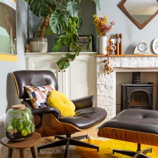 living room colour schemes, retro living room with pale blue walls and pops of yellow, retro furniture, fireplace, plants